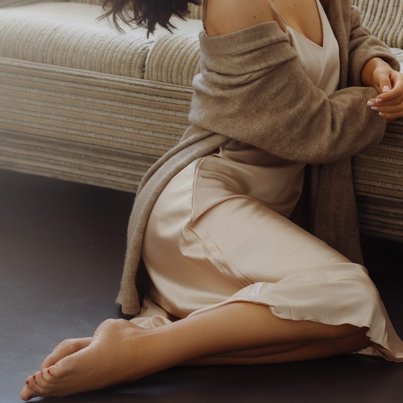 Young woman sitting on the sofa in the living room.